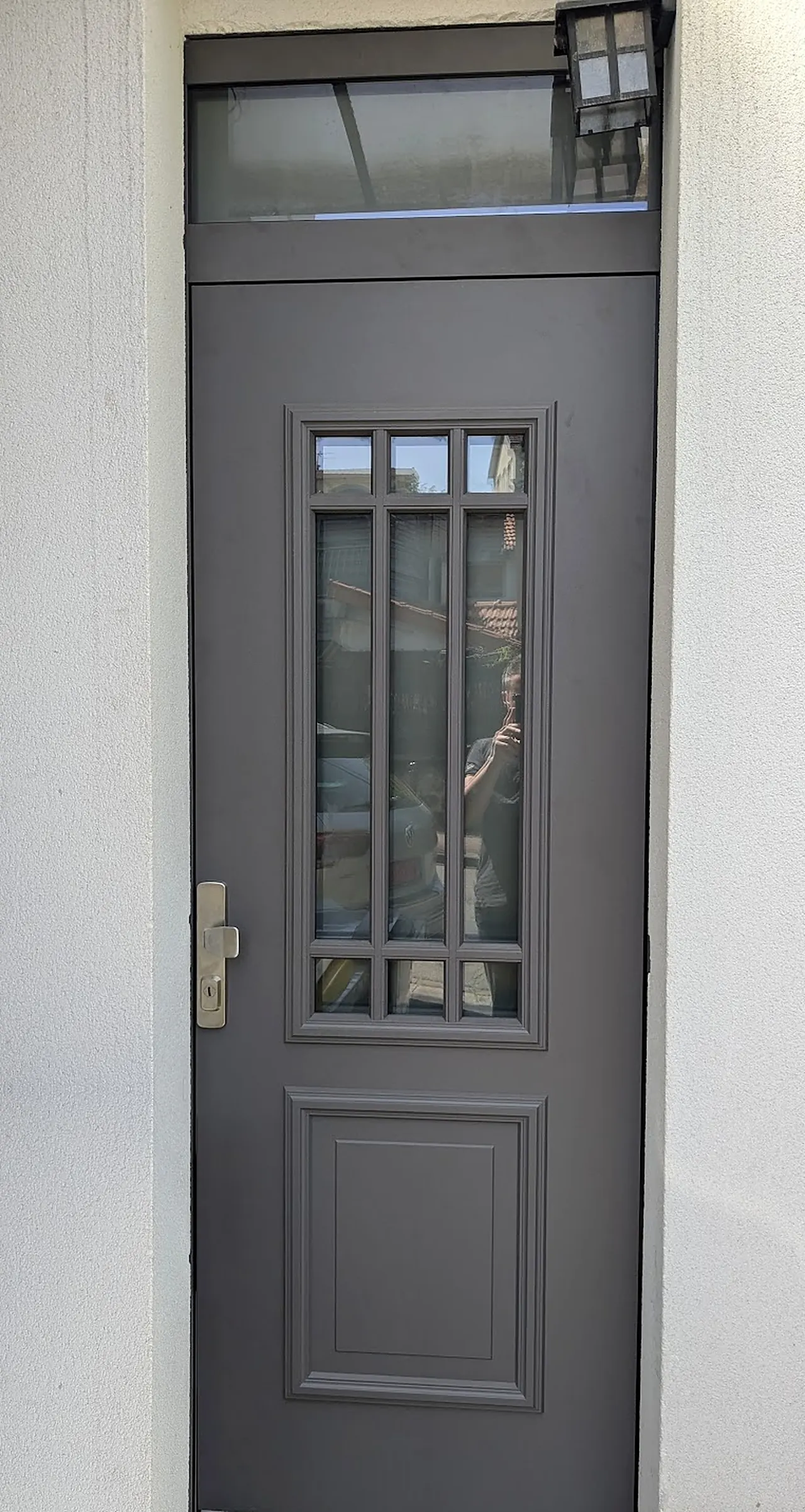 Porte d'entrée en aluminium gris foncé, moulurée, à petits-bois vitrés et imposte vitrée, à Suresnes