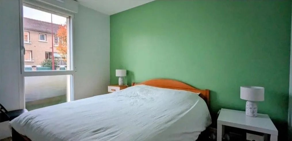 Après : chambre avec mur vert et sol clair