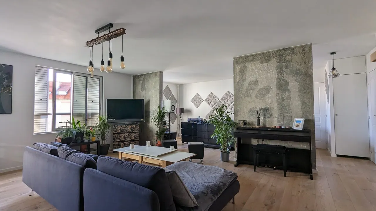 Séjour rénové par JLS Bâtiment, mur décoratif végétal et parquet clair